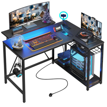 Bestier Gaming Desk with Power Outlets, 42" L-Shaped Computer Desk with LED Lights, Desk with Reversible Storage Shelves & Hooks for Small Spaces, Bedrooms & Offices, Black Carbon Fiber